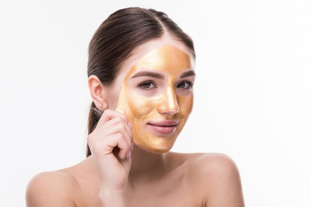 beautiful woman with golden skincare treatment