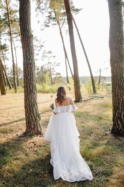 romantic photo fairy forest beautiful girl in wedding dresses with sleeves