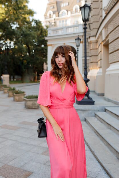 pretty romantic woman in pink long dress