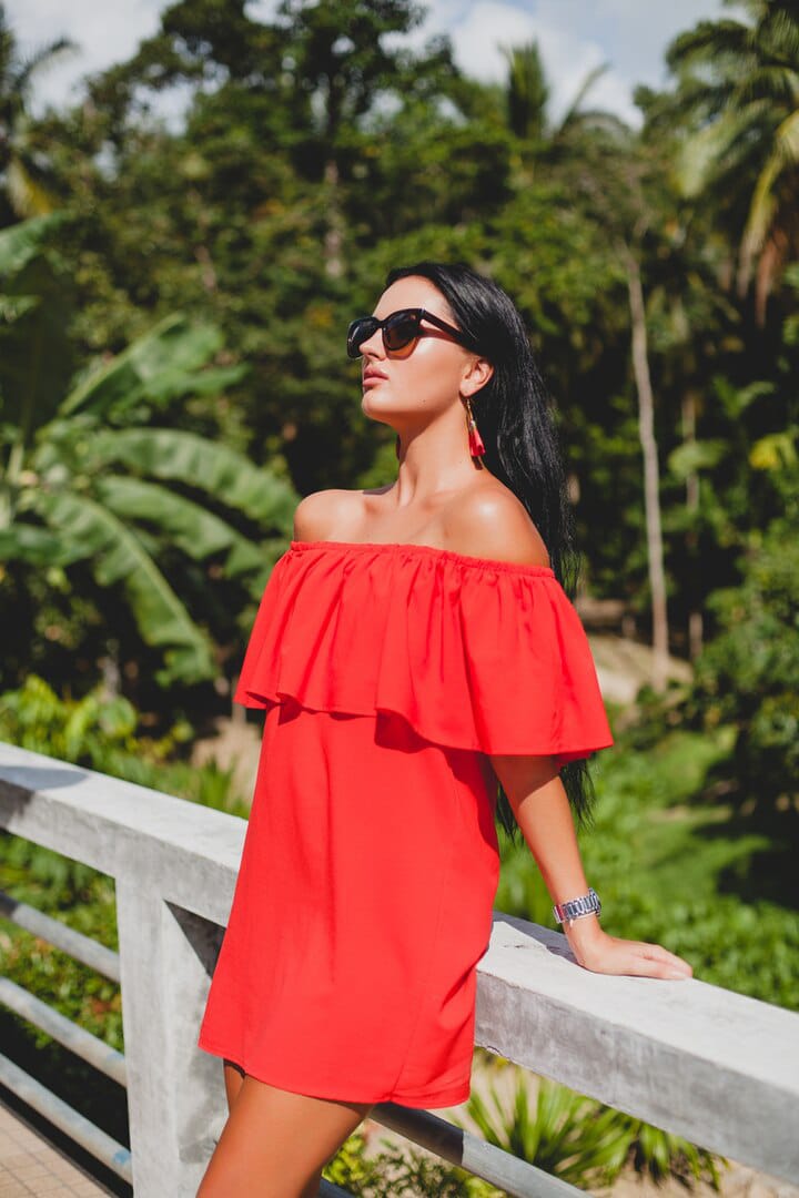 Beautiful girl posing in red off the shoulder dress