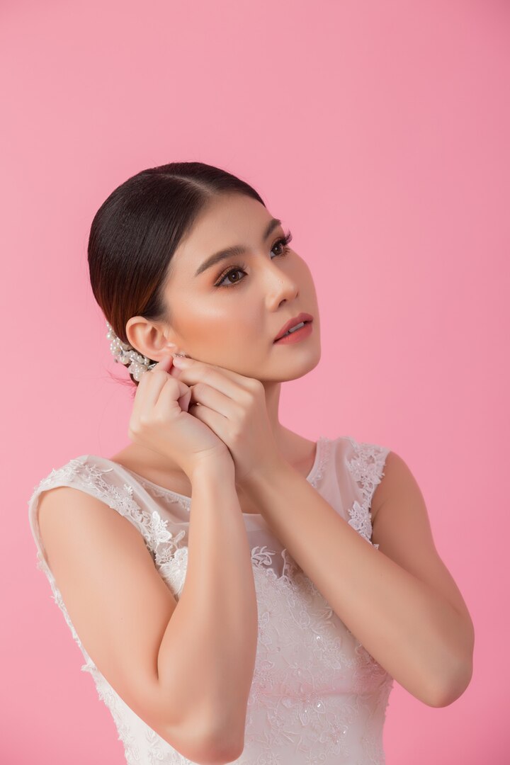 beautiful asian bride looking pretty wearing bridal earrings