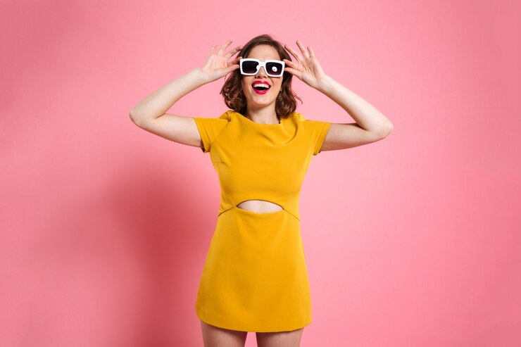 beautiful girl posing in yellow mini dress