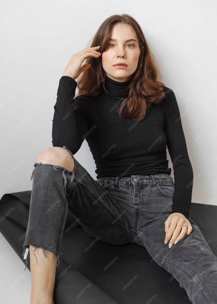 posing girl wearing black top and black jeans