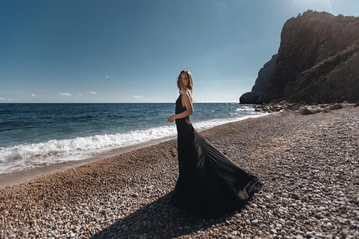 Posing girl on beach Black wedding dress