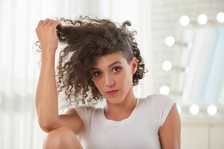 beautiful woman touching her curly hair