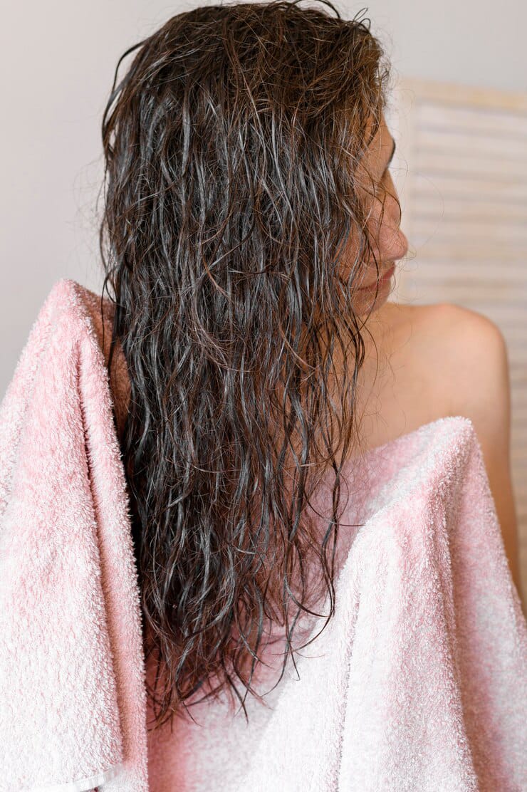 girl drying her hair from towel