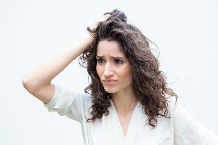 pretty woman holding our frizz hair