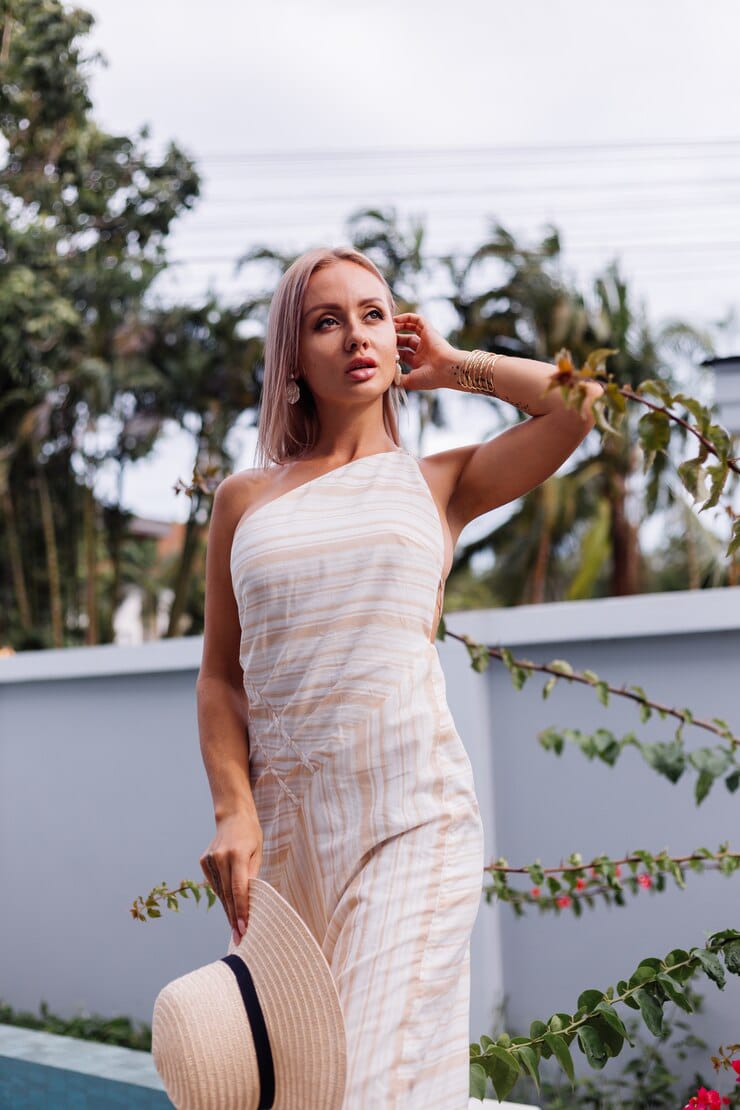 pretty woman posing in white one shoulder dress