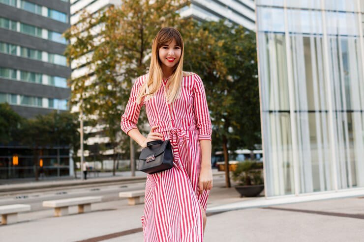 Beautiful girl in striped shirt dress with coat