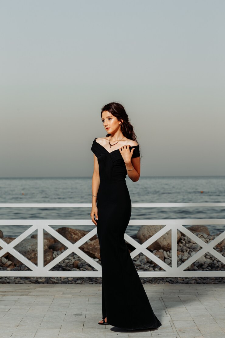 young woman posing in black tie dresses