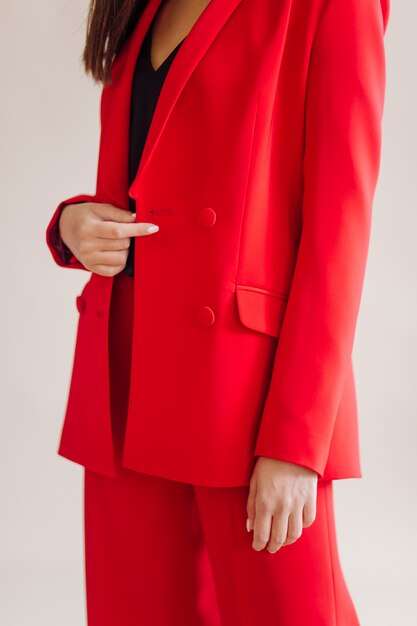 young woman wearing red blazer pant suit