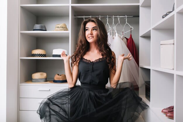 pretty young women standing dressing room looking her beautiful black gown