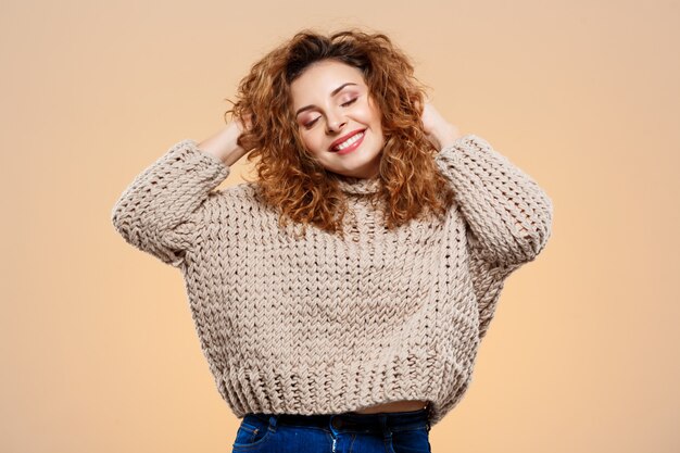 beautiful smiling woman wearing cropped sweater with high-waisted jeans