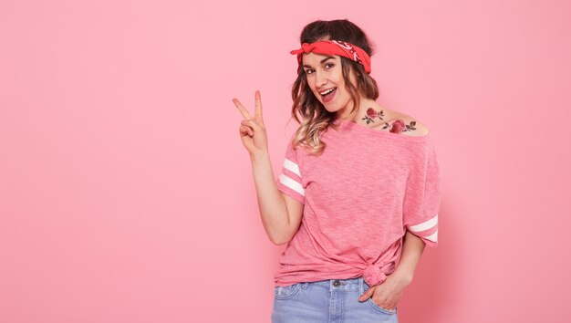 happy women posing in pink top with jeans