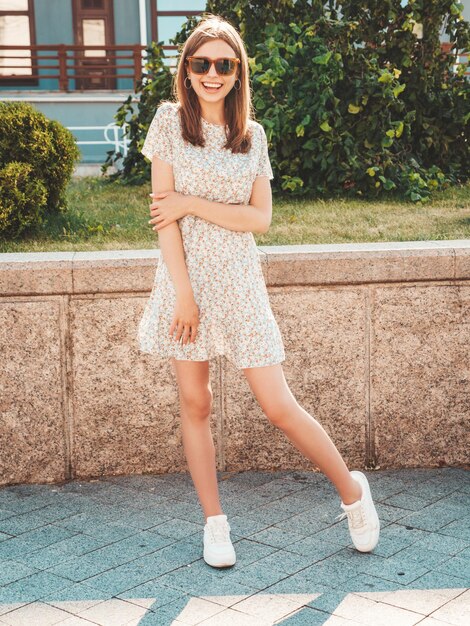 trendy summer look casual dress with sneakers posing street