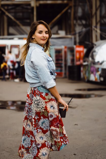 beautiful young woman with long hair denim jacket with maxi dress