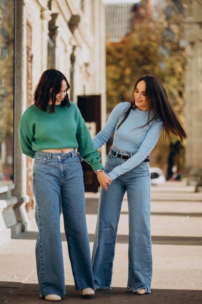 two girls posing look wearing top with wide leg pants